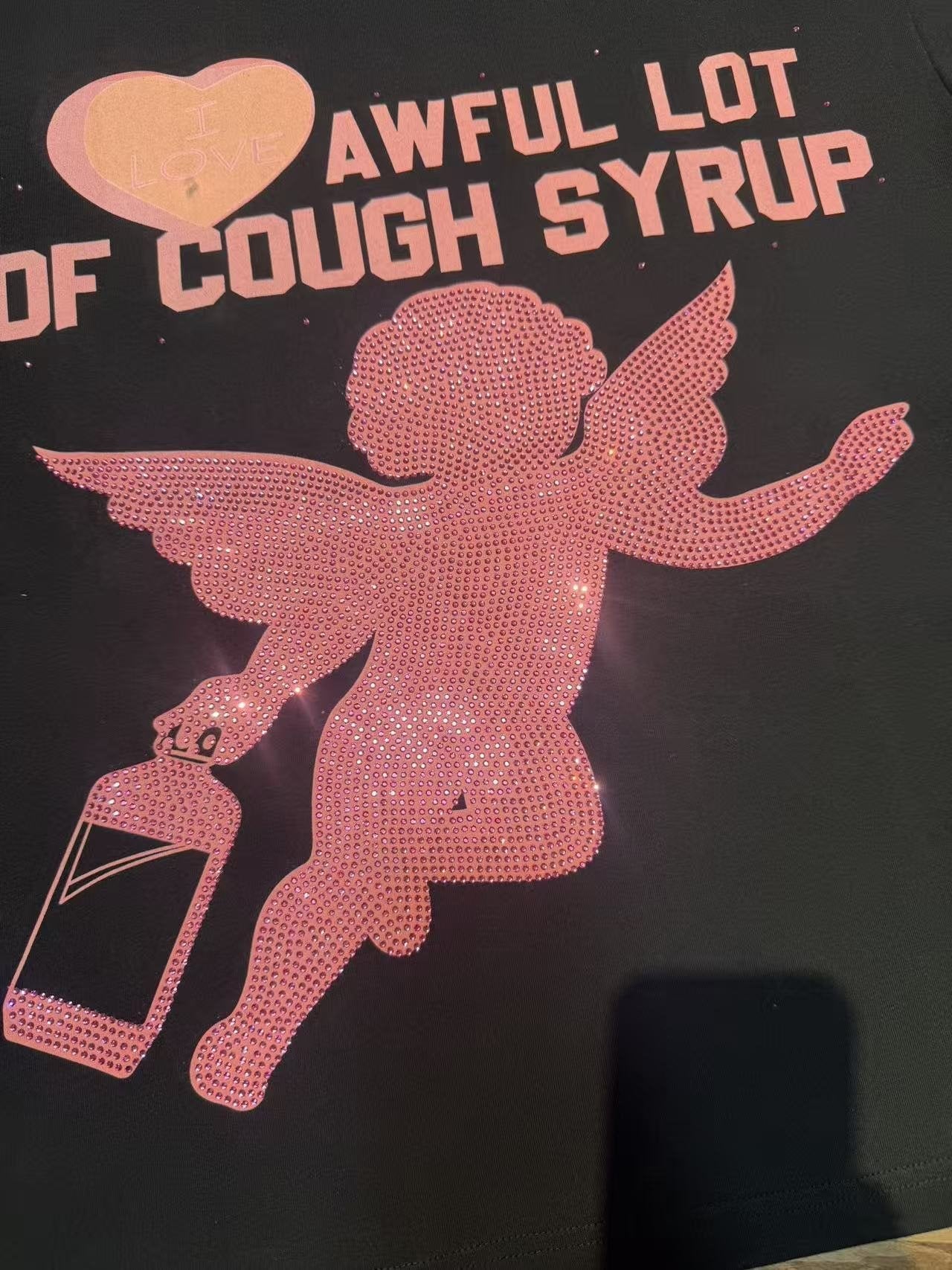 THAT'S A AWFUL LOT OF COUGH SYRUP Heart Cupid Graphic T-Shirt — fabric_closeup
